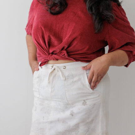 White cotton denim mini skirt eco printed with dark grey rose leaves and iron prints