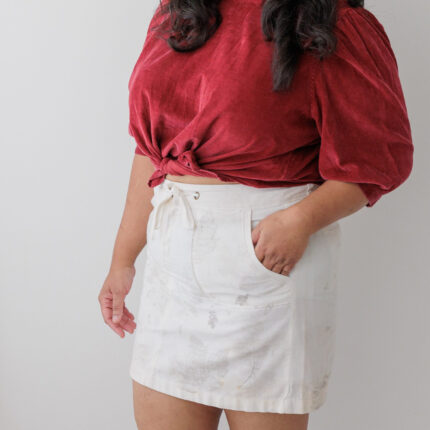 White cotton denim mini skirt eco printed with dark grey rose leaves and iron prints