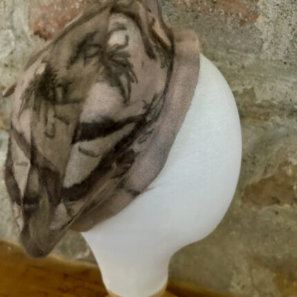 Pale pink wool beret eco printed with dark brown long ecucalyptus eaves and dark brown black spiky tamarisk leaves